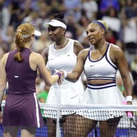 Image: Venus and Serena Williams shake hands with Maya Joint and Chan Hao-ching after losing their women's doubles match at the U.S. Open.