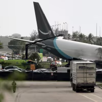 Amazon Cargo Plane tilted on its side off an airport tarmac