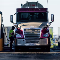 Drivers refuel trucks with diesel fuel at a Pilot gas station