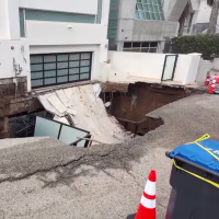 A driveway in front of a vacant seaside Malibu home collapsed early this morning after steady rainfall and high surf pounded the Los Angeles County coast.