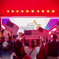 Attendees hold American flag placards during the Republican Midterm Convention.