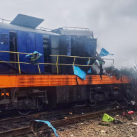 A damaged locomotive is seen on train tracks outside