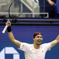 Alexander Zverev celebrates with both fists raised into the air.