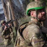 Ukrainian servisemen patrols a road near Kramatorsk