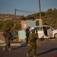 Israeli security forces inspect the scene.