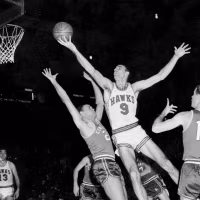 A black and white photo of on-court action during an NBA game.