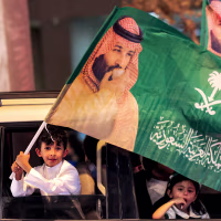 A child waves a flag of Saudi Crown Prince Mohamed Bin Salman