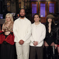A group portrait of Jalen Brunson and Katseye on stage during an SNL taping.