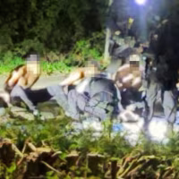 An image circulating on social media shows handcuffed suspects near RAF Fairford Air Base, England, on Sunday.