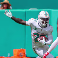 Miami Dolphins running back De'von Achane (28) threads the gap for extra yardage in the first half against the Kanas City Chiefs game at Hard Rock Stadium in Miami Gardens, Fla., on Sunday, Sept. 27, 2026. (Carl Juste/Miami Herald/Tribune News Service via Getty Images)