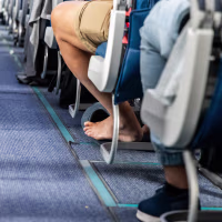 Bare foot airplane passenger with shoes removed during long haul flight for comfort