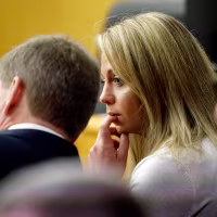 Image: Fired Dallas police officer Amber Guyger listens to her attorney at court on Sept. 24, 2019.