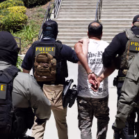 ICE agents walk a detainee out of the Ventura County Government Center in Ventura, CA.