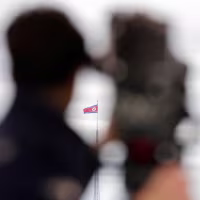 A North Korean flag flutters in the wind 