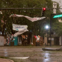 Debris is seen in an intersection as wind and rain passes through.