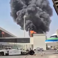 Black smoke and flames rising from a fire 