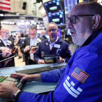 Traders work on the floor.