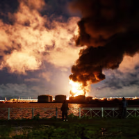 Image: Smoke rising from a burning oil terminal in Saint Petersburg.