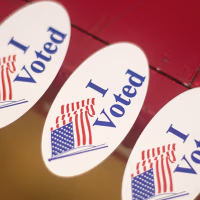 "I Voted" stickers with American flag graphics.