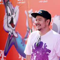 Image: Eric
Bauza at a film premiere, with an image of Bugs Bunny on a backdrop behind him.