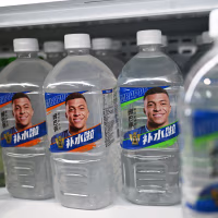 Image: Kylian Mbappe's face on Dongpeng electrolyte drink bottles.