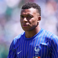 Image: Kylian Mbappe wearing a blue France jersey.