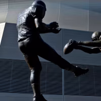 NEW ORLEANS, LOUSIANA - OCTOBER 7: A statue titled Rebirth featuring the likeness of former New Orleans Saints safety Steve Gleason blocking a punt by former Atlanta Falcons punter Michael Koenen on September 25, 2006 as seen outside before a game against the San Diego Chargers at the Mercedes-Benz Superdome on October 7, 2012 in New Orleans, Louisiana.  (Photo by Derick E. Hingle/Getty Images)