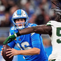 Detroit Lions quarterback Jared Goff (16) looks to pass against New York Jets linebacker Demario Davis (56) during the second half at Ford Field in Detroit on Sunday, Sept. 27, 2026.