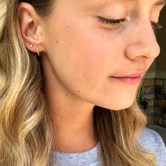 Split image of Editor wearing and holding the Pavoi 14K Gold-Plated Cuff Earrings