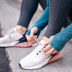 Woman tying her running shoes
