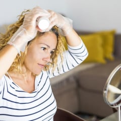 Woman dying her hair at home