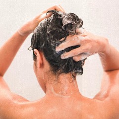 Woman Washing Hair In Bathroom At Home