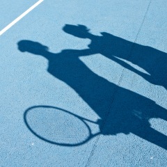 Shadow of tennis players on tennis court
