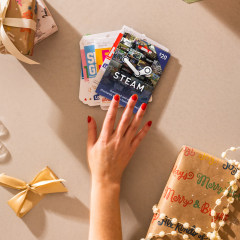 Hand on gift cards, a Nintendo and a mouse