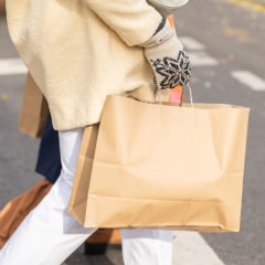 Woman holding a brown shopping bag
