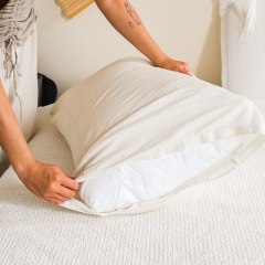 Woman putting on a pillow case