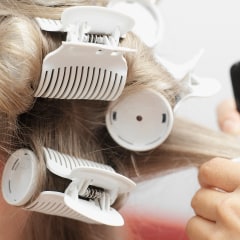 Hairdresser putting in curlers