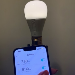 Split image of a Woman on her phone and a close up of a phone and light bulb