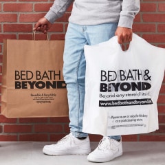 Hand holding some Bed Bath and Beyond bags