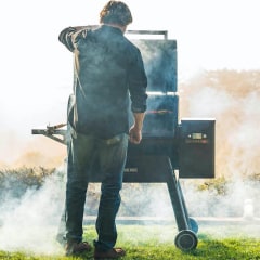 Man standing outside in front of a smoker