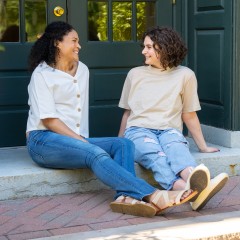 Two Women sitting on steps outdoors
