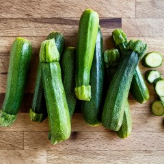 Fresh zucchini on wooden background