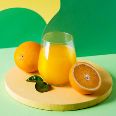 Orange juice in glass and oranges studio still life.