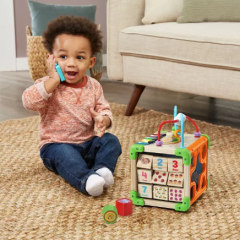 Child playing with LeapFrog Touch & Learn Wooden Activity Cube. 