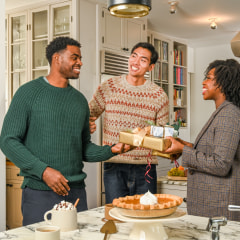 three people exchanging gifts with their brother in law