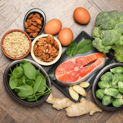 Different fresh products rich in melatonin on wooden table, flat lay