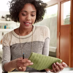 Interior designer browsing fabric swatches at home office desk