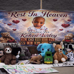 A baby's face on a memorial banner outside a Walmart.
