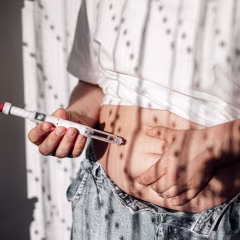 Injections for weight loss with Semaglutide. An obese woman gives a hormonal injection into the abdomen with a pen syringe.