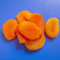 Dried apricots on a blue background